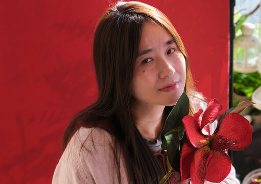 Chinese women on a balcony wiht red flower&mdash;Chinese New Year