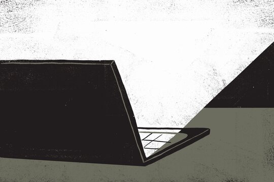 Laptop on the desk in the dark room