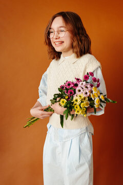 Young girl with flowers minimal studio shot

