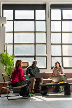 Casual Business Meeting With Diverse Coworkers and Laptop
