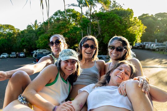 UGC group of friends sitting on top of a van in parking lot