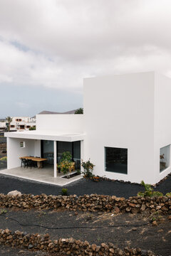 From wide perspective, the rear side of a contemporary minimalist home