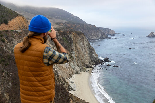 Photographer selective focus view Big Sur, California 