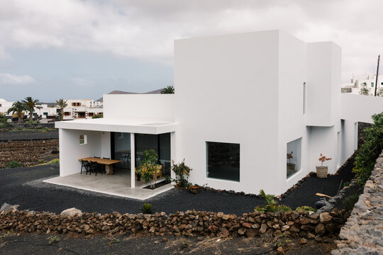 A wide shot of the rear of a modern, minimalist designer home