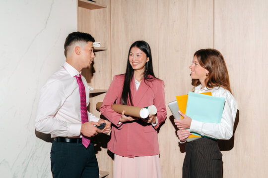 Team of young professionals talking in the office