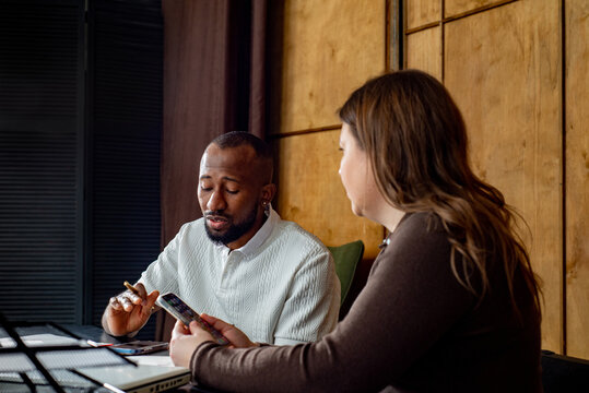 Two employees talk to each other in office
