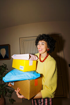 Woman receiving multiple home delivery packages with joy ugc