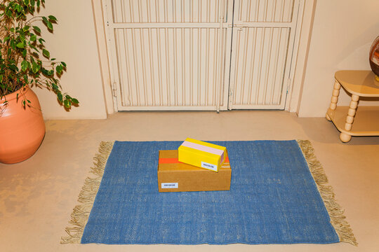 Packages arriving on front doorstep for home delivery ugc
