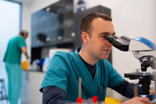 Scientist checks samples under microscope