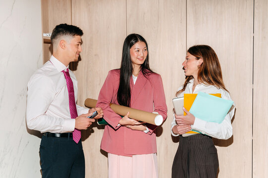 Team of young professionals talking in the office