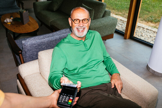 Business Senior Man Paying with Card