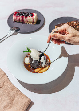 Three vegan desserts with spoon poking into a sticky toffee pudding