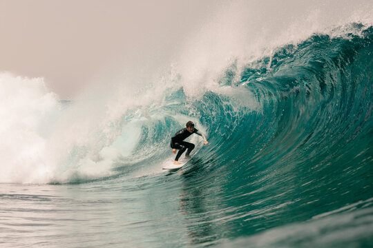 Elite surfer riding a massive wave during an open-water training