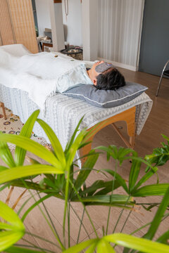 Massage Session in a Wellness Center With a Relaxed Person