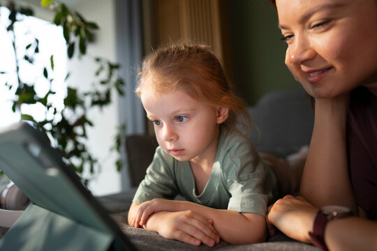 Mother and child watching video on tablet