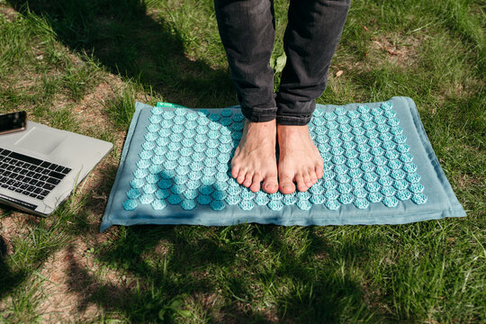 Relaxing Feet on a Textured Mat Under the Warm Sun in Nature