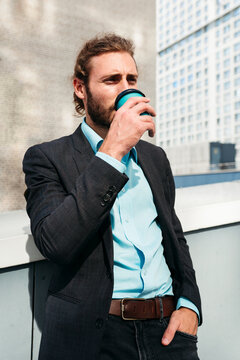 Stylish Man Enjoying Coffee on a Modern Rooftop Terrace