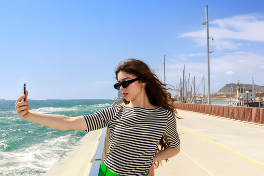 Woman Takes Selfie by the Sea 