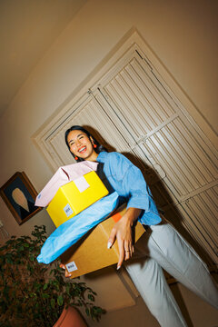 Woman enjoying many packages from online shopping delivery ugc