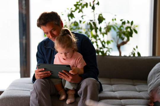 Family learning moment with tablet at home