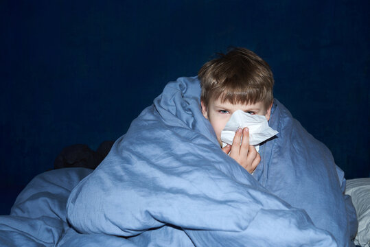 Ill child covered with blanket
