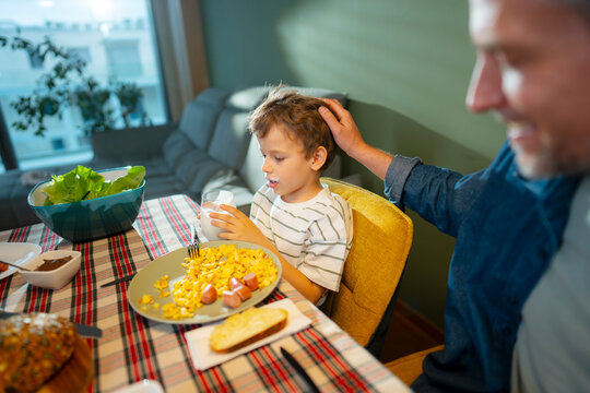 Dad and son share breakfast at home