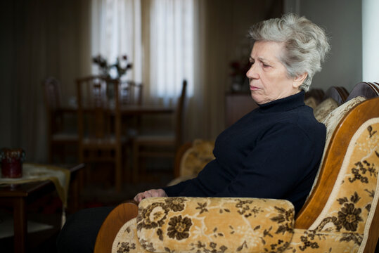 Elderly woman sitting alone thinking about loneliness and sadness