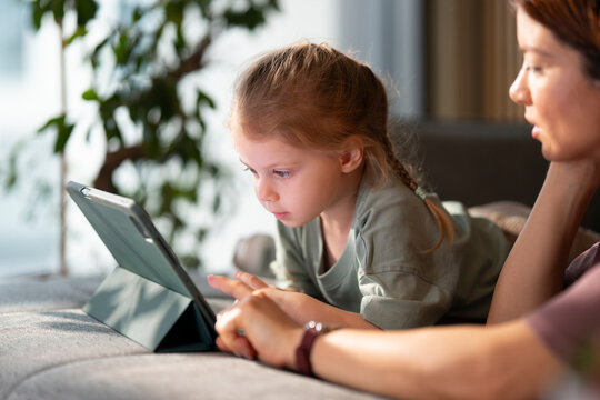 Mother and child looking at a tablet together