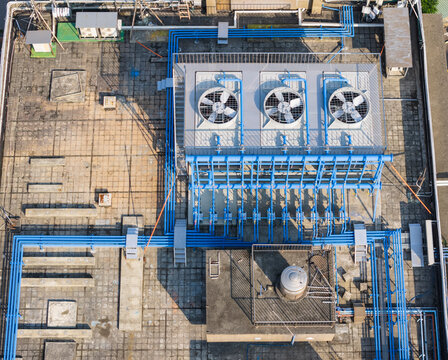 Industrial Rooftop HVAC Cooling System and Blue Pipes