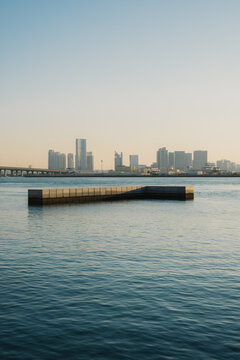 Floating platform on calm water with city skyline