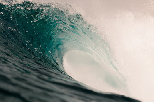 Enormous ocean waves surge and break violently in open water