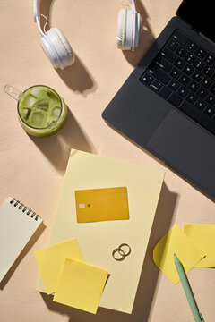 Overhead view of a workspace with laptop and credit card