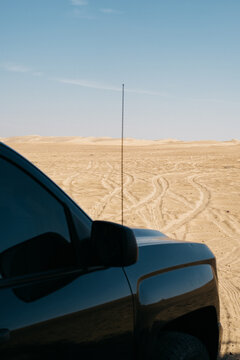Black truck in Abu Dhabi desert under midday sun