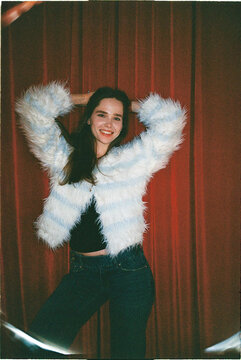 Young woman poses with confidence in fluffy jacket
