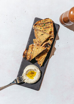 Slide of toasted bread with hummus