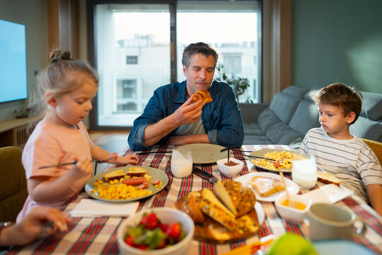Family enjoys breakfast together in a home setting