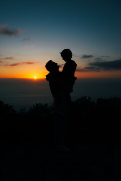 Silhouette of parent and child at La Palma sunset coast