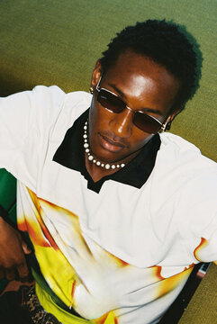 Portrait of man in sunglasses and necklace film photo