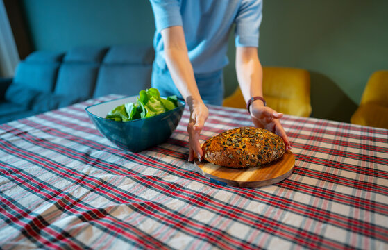 Preparing food on a table with salad and bread
