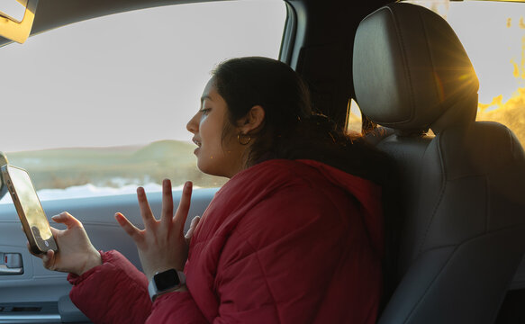 Girl singing along on a sunset drive 