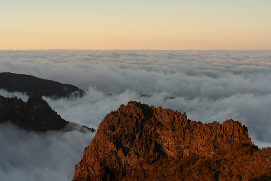 Sunlit mountain ridge above clouds Madeira