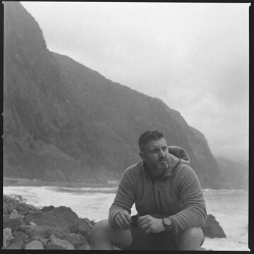 Man portrait on rocky coast Madeira black and white