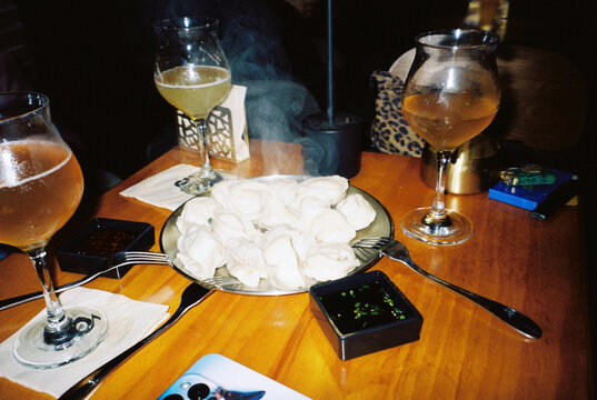 Wine Glasses and Dumplings on Table Close Up Dining Scene