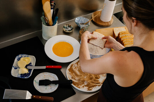 Woman making traditional Spanish Torrijas on a quiet morning