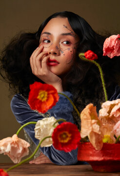 Portraits of women with floral-themed makeup, and flowers