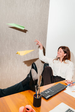 Woman Has Fun With Paper Planes During a Break In the Office