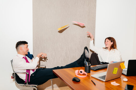 Team Members Have Fun With Paper Planes During a Break In the Office