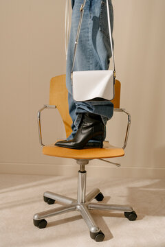 Fashionable Handbag and Boots on Chair