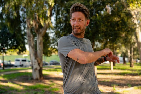 Man Stretching and Looking Sideways Outdoors