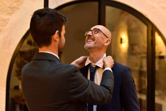 Same-sex couple at home getting ready together for evening